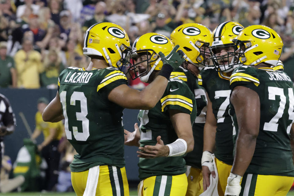 Green Bay Packers wide receiver Allen Lazard (13) celebrates with teammate quarterback Aaron Rodgers (12) after catching a 5-yard touchdown pass during the first half of an NFL football game against the Chicago Bears Sunday, Sept. 18, 2022, in Green Bay, Wis. (AP Photo/Mike Roemer)