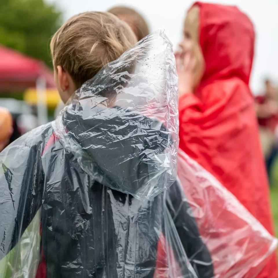 a child in a poncho at an outdoor event