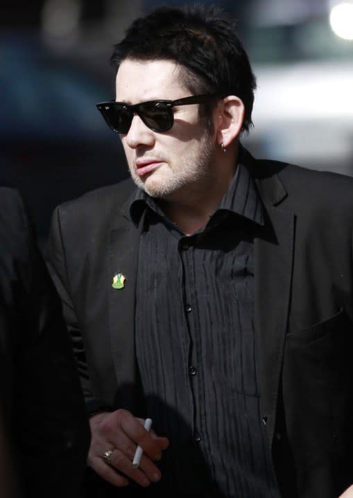 FILE – Irish singer Shane MacGowan attends the funeral mass of Irish poet Seamus Heaney at the Church of the Sacred Heart in Donnybrook, Dublin, Ireland, Monday, Sept. 2, 2013. Macgowan, the singer-songwriter and frontman of The Pogues, best known for their ballad “Fairytale of New York,” has died. He was 65. His family said in a statement that “it is with the deepest sorrow and heaviest of hearts that we announce the passing of our most beautiful, darling and dearly beloved Shane Macgowan.” The singer died peacefully early Thursday, Nov. 30, 2023 with his family by his side, the statement added. (AP Photo/Peter Morrison, File)