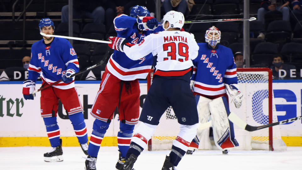 NEW YORK, NEW YORK - MAY 05: Pavel Buchnevich #89 of the New York Rangers takes a high-sticking penalty on Anthony Mantha #39 of the Washington Capitals during the second period at Madison Square Garden on May 05, 2021 in New York City. (Photo by Bruce Bennett/Getty Images)