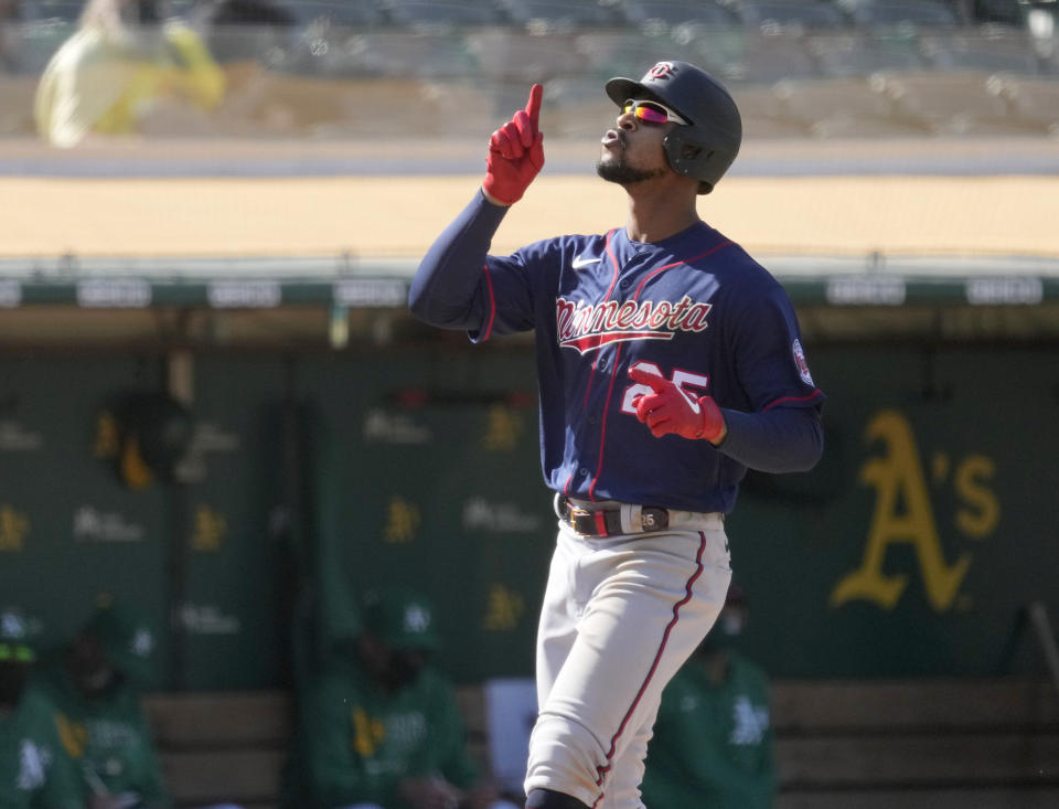 Minnesota Twins' Byron Buxton (25) points to the sky after hitting a two run home run against Oakland Athletics during the tenth inning of a baseball game on Wednesday, April 21, 2021, in Oakland, Calif. (AP Photo/Tony Avelar)