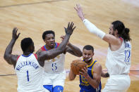Golden State Warriors guard Stephen Curry throes to go to the basket under pressure from New Orleans Pelicans center Steven Adams (12), forward Zion Williamson (1) and guard Eric Bledsoe (5) in the first half of an NBA basketball game in New Orleans, Tuesday, May 4, 2021. (AP Photo/Gerald Herbert)