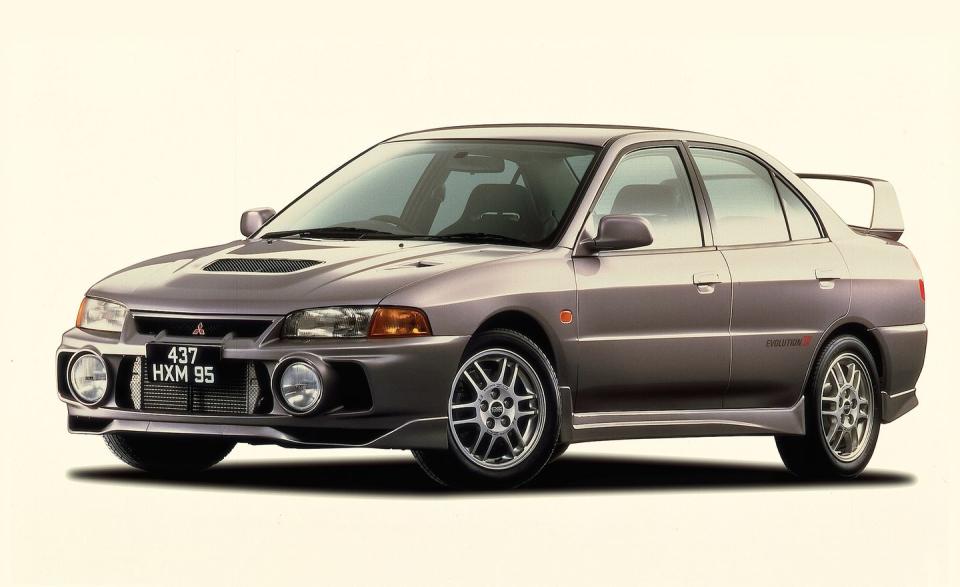 Fueled by Mäkinen’s success, the legend of the Mitsubishi Evo soon spread beyond Japan. (That the first iteration of the Gran Turismo franchise, released in late 1997, included the Evo III and IV no doubt also helped.) The Evo IV, which debuted in 1996, was based on a new-generation Lancer platform and the revised powertrain, which included a new twin-scroll turbocharger and gained an additional 10 horsepower. An active rear differential was included for the first time as part of a new Active Yaw Control (AYC) system; it used various sensors and a computer to redistribute torque to whichever of the four wheels could use it best. And, of course, the body was completely new in appearance.