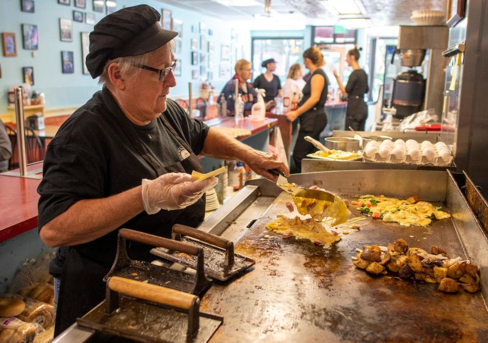 Annie Jenkins makes omelets on the grill Friday at Annie’s Clark Brunch in Worcester.