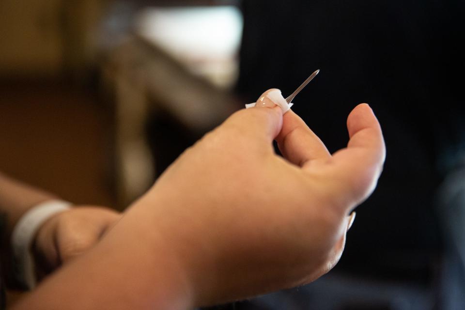 Joanie Garza, a public health inspector with the city, cleans off a thermometer after checking the temperature of macaroni in warm holding during a restaurant inspection June 6, 2023, in Corpus Christi, Texas.