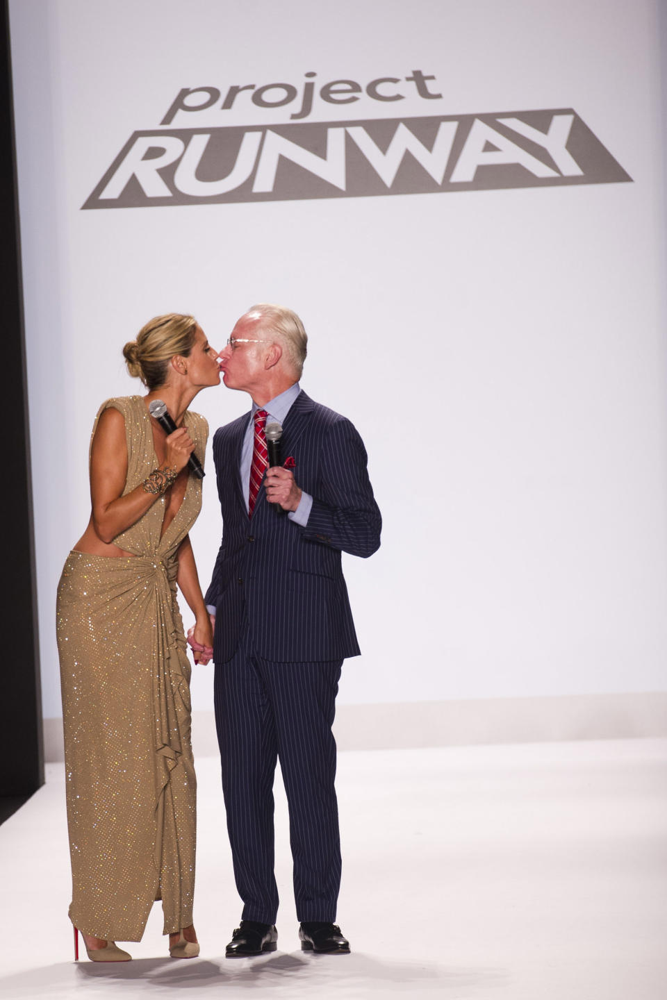 Heidi Klum, left, and Tim Gunn walk the runway at the Project Runway finale fashion show during Fashion Week on Friday, Sept. 7, 2012 in New York. (Photo by Charles Sykes/Invision/AP Images)