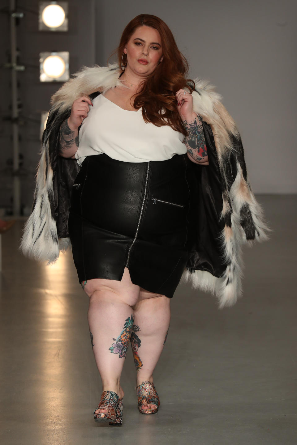 <p>Strutting her stuff in a leather skirt and fur jacket. </p>