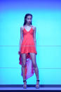 <b>LFW AW13: Rihanna for River Island</b><br><br>Bight colour-pop mini-dress with longer train behind. <br><br>©Rex