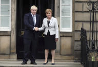 Scotland's First Minister Nicola Sturgeon, right, shakes hands with Britain's Prime Minister Boris Johnson, outside Bute House, ahead of their meeting, in Edinburgh, Scotland, Monday July 29, 2019. Johnson made his first official visit as British prime minister to Scotland, pledging to boost "the ties that bind our United Kingdom" amid opposition from Scottish leaders to his insistence on pulling Britain out of the European Union with or without a deal. (Jane Barlow/PA via AP)