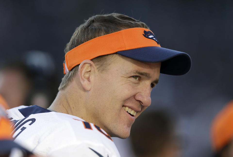 FILE - Denver Broncos quarterback Peyton Manning smiles while standing on the sideline during the second half of an NFL football game against the Oakland Raiders in Oakland, Calif., in this Sunday, Dec. 29, 2013, file photo. Peyton Manning never wanted to leave Indianapolis. But when a neck injury forced him to miss a season and the Colts moved on to Andrew Luck, he couldn’t have landed in a better place than Denver, where he produced a terrific second chapter to his Hall of Fame career. (AP Photo/Marcio Jose Sanchez, File)