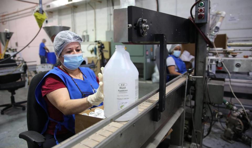 Due to the coronavirus pandemic Toast distillers began partnering with Cosmetic Corp. an FDA approved lab in Medley, to use their alcohol to produce hand sanitizer. On Tuesday, June 23, 2020, Alina Gonzalez places labels on large jars of the EZ Hand Sanitizer as it moves down the production line at the facility inside of the Cosmetic Corp. building.
