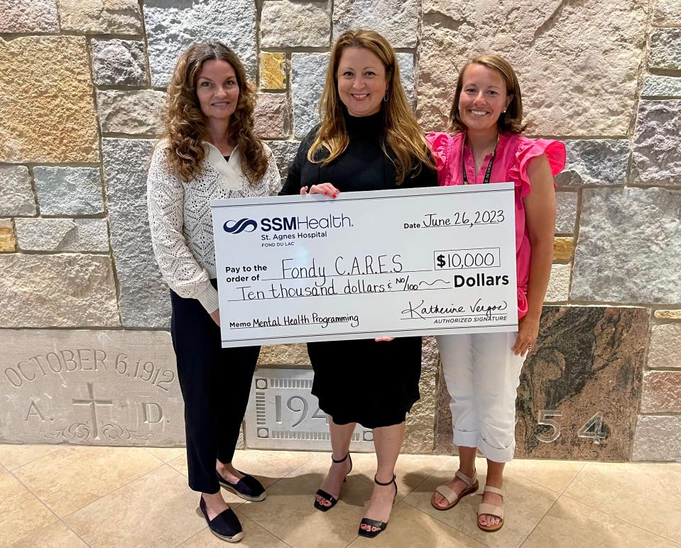 Katherine Vergos, center, SSM Health St. Agnes Hospital president, presents a $10,000 donation to the Fondy CARES Mental Health Navigators, Patti Shippee, left, and Melissa Schepp.