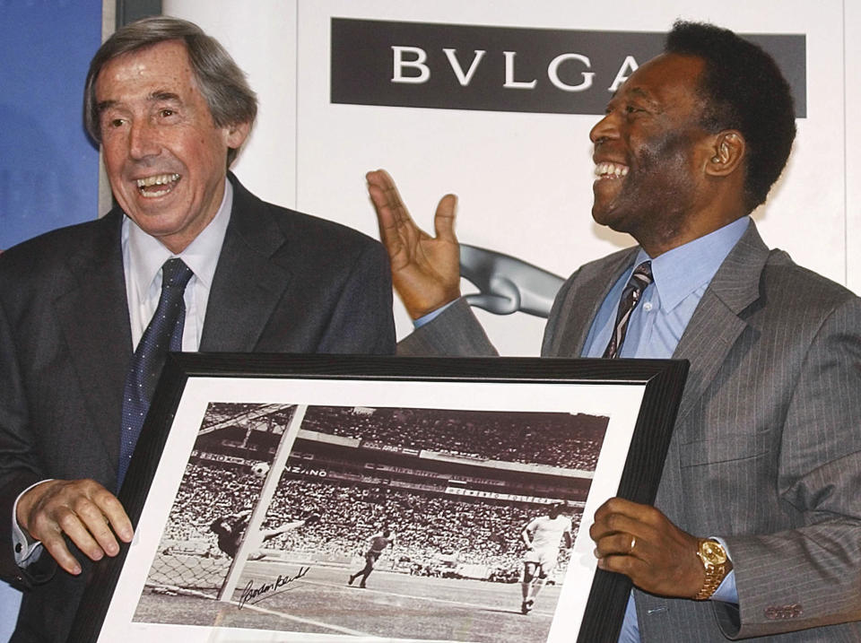 FILE - In this Thursday March 4, 2004 file photo Brazilian soccer legend Pele, right, presents former England goalkeeper Gordon Banks with a photograph showing Banks saving a header from Pele in the 1970 World Cup, at a press conference in London, to mark FIFA's 100 year anniversary. English soccer club Stoke said Tuesday Feb. 12, 2019 that World Cup-winning England goalkeeper Gordon Banks has died at 81. (AP Photo/Max Nash, File)