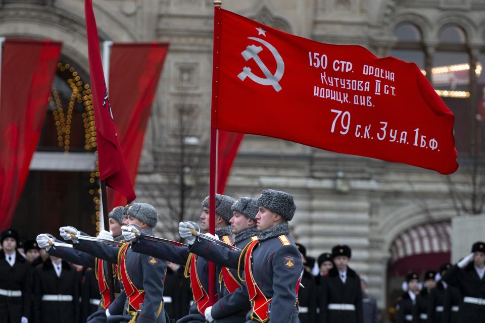 Russian soldiers carry a replica of the Victory banner during a reconstruction of a World War II-era parade in Moscow's Red Square, Russia, Thursday, Nov. 7, 2019. The Nov. 7, 1941 parade saw Red Army soldiers move directly to the front line in the Battle of Moscow, becoming a symbol of Soviet valor and tenacity in the face of overwhelming odds. (AP Photo/Alexander Zemlianichenko)