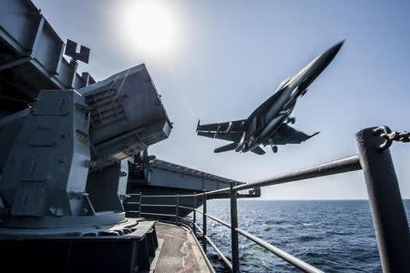 A U.S. Navy F/A-18 launches from the USS Carl Vinson in this undated handout picture released November 1, 2014. REUTERS/US Navy/Handout via Reuters