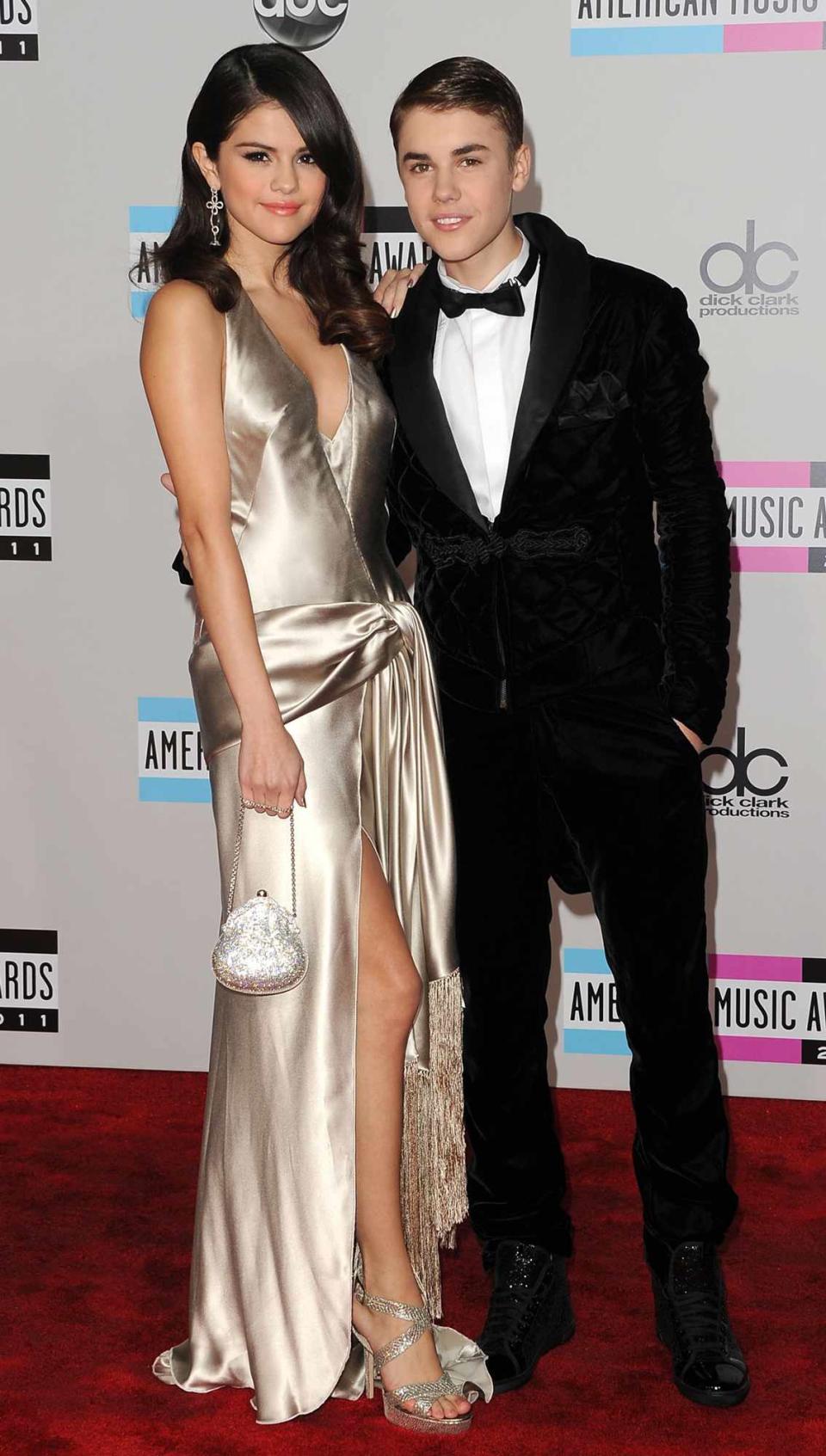 Selena Gomez (L) and Justin Bieber arrive at the 2011 American Music Awards held at Nokia Theatre L.A. LIVE on November 20, 2011 in Los Angeles, California