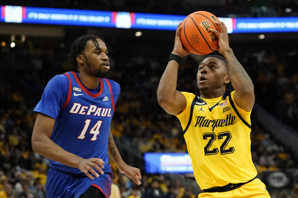 Marquette's Sean Jones drives to the basket against DePaul's Nick Ongenda during the first half of an NCAA college basketball game Saturday, Feb. 25, 2023, in Milwaukee. (AP Photo/Aaron Gash)