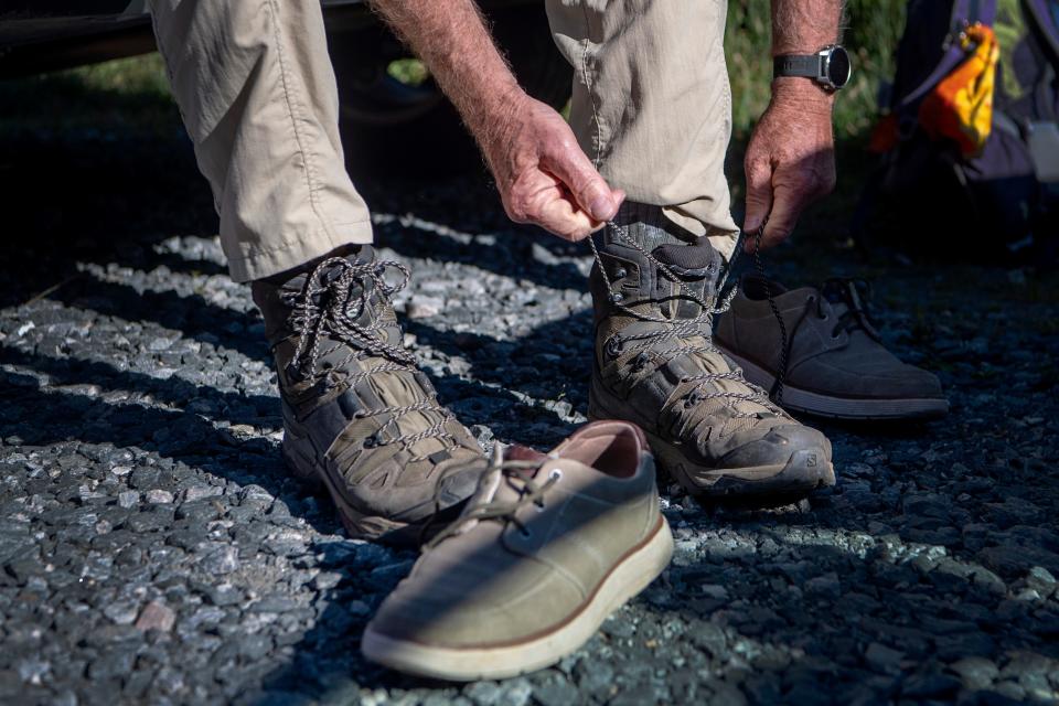 Jim Magura laces up his boots as he prepares to lead the Carolina Mountain Club to Tennent Mountain July 12, 2023.