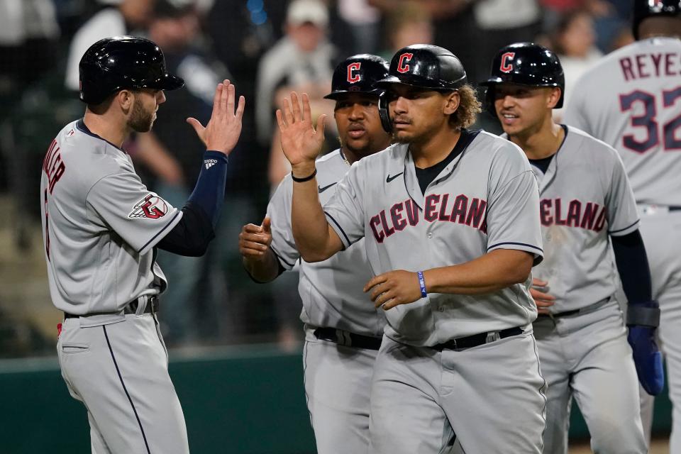 Guardians first baseman Josh Naylor, center, celebrates his score-tying grand slam off Chicago White Sox relief pitcher Liam Hendriks in the ninth inning of Monday night's game. Naylor hit a three-run homer in the 11th to give the Guardians a 12-9 win. [Charles Rex Arbogast/Associated Press]