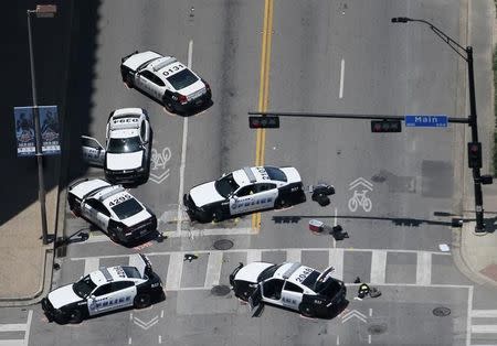 Police cars remain parked with the pavement marked by spray paint, in an aerial view of the crime scene of a shooting attack in downtown Dallas, Texas, U.S. July 8, 2016. REUTERS/Brandon Wade