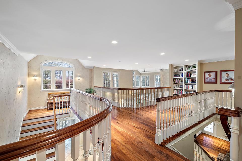 Landing on the 2nd level that overlooks the kitchen at 920 Pine Needle Trail in Oakland Township.