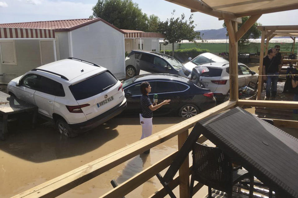 A TV reporter reports from a flooded campsite in the Cabo de Gata area, near Ruescas, Almeria in south-eastern Spain, Friday Sept. 13, 2019. Spanish authorities say that heavy storms in the southeast have claimed another victim, bringing the death toll from the extremely bad weather to three. (AP Photo/Serge Carthwright)