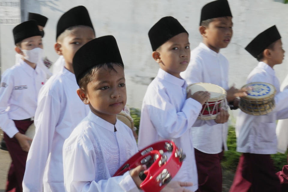 Indonesian students march during a parade marking Ramadan in Jakarta, Indonesia, Tuesday, March 21, 2023. Ramadan, the holy fasting month, is expected to begin on Thursday. Indonesia is the world's most populous Muslim nation. (AP Photo/Achmad Ibrahim)