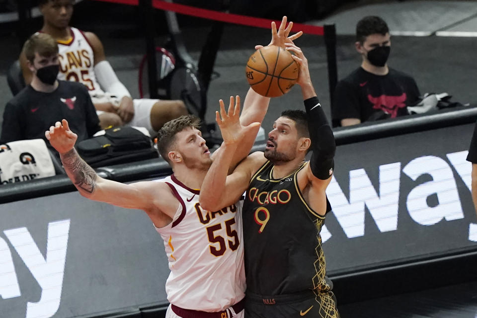 Chicago Bulls center Nikola Vucevic, right, drives to the basket against Cleveland Cavaliers center Isaiah Hartenstein during the second half of an NBA basketball game in Chicago, Saturday, April 17, 2021. (AP Photo/Nam Y. Huh)