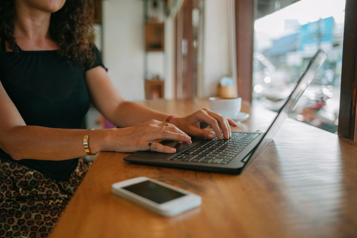 Woman working remotely in a café