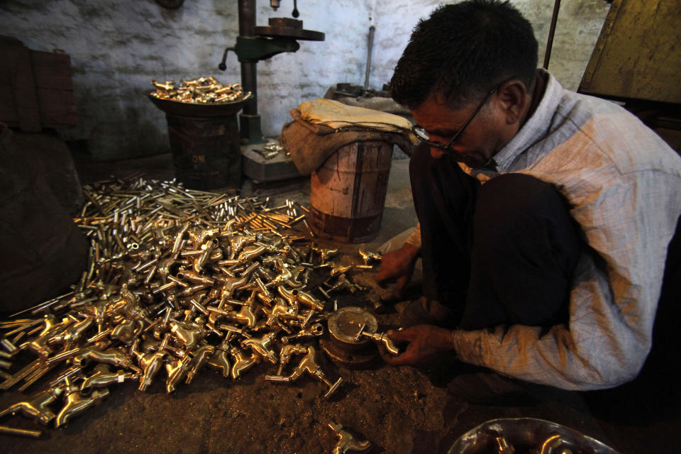 An Indian worker makes brass water taps at a factory on the outskirts of Jammu, India, Wednesday, Feb. 29, 2012. India's economy grew at its slowest pace in over two years in the December quarter, adding to pressure on the central bank to lower interest rates even as inflation remains high. The 6.1 percent growth reported Wednesday marks a sharp slowdown from a 6.9 percent expansion in the July-September quarter. (AP Photo/ Channi Anand)