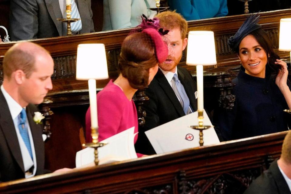 Prince William, Kate, Prince Harry and Meghan take their seats (AFP/Getty Images)