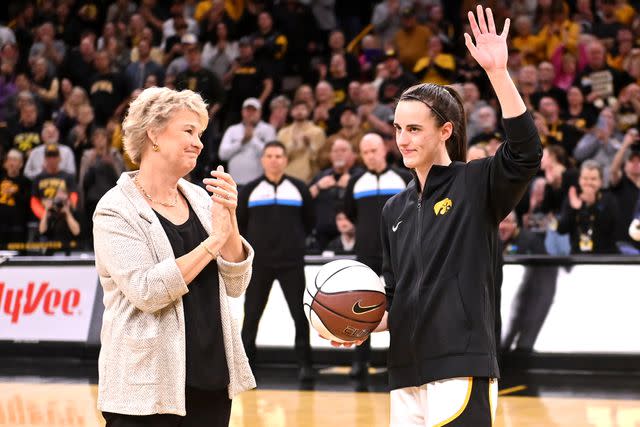 <p>Keith Gillett/Icon Sportswire via Getty</p> Lisa Bluder looks on as Caitlin Clark is recognized for breaking the Big Ten's all-time women scoring record in February 2024.