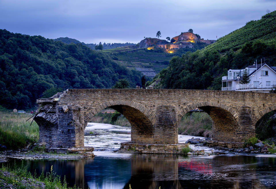 A damaged bridge stands at the Ahr river in the village of Rech in the Ahrtal valley, Germany, Tuesday, July 5, 2022. Flooding caused by heavy rain hit the region on July 14, 2021, causing the death of about 130 people. (AP Photo/Michael Probst)