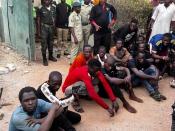 Inmates who escaped during the attack wait after being returned back to Kuje prison, in Abuja