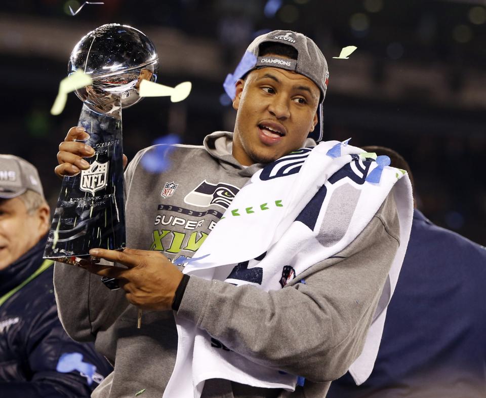 Seattle Seahawks' Malcolm Smith (53) holds the Vince Lombardi Trophy after the NFL Super Bowl XLVIII football game against the Denver Broncos, Sunday, Feb. 2, 2014, in East Rutherford, N.J. The Seahawks won 43-8. (AP Photo/Evan Vucci)