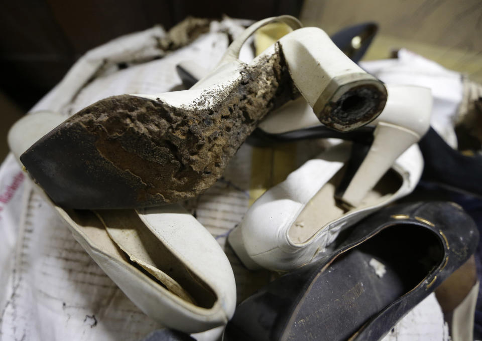 In this photo taken Sept. 19, 2012, a branded high heel shoe, once worn by flamboyant former Philippine first lady Imelda Marcos sits among equally-damaged shoes in a section of the National Museum in Manila, Philippine. Termites, storms and government neglect have damaged some of Imelda Marcos's legendary stash of shoes, expensive gowns and other vanity possessions, which were left to oblivion after she and her dictator husband were driven to U.S. exile by a 1986 popular revolt. (AP Photo/Bullit Marquez)