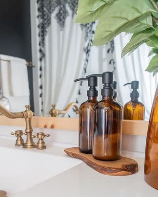 A pair of amber soap dispensers