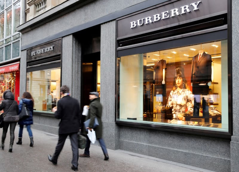 FILE PHOTO: People walk past a store of British luxury brand Burberry in Zurich