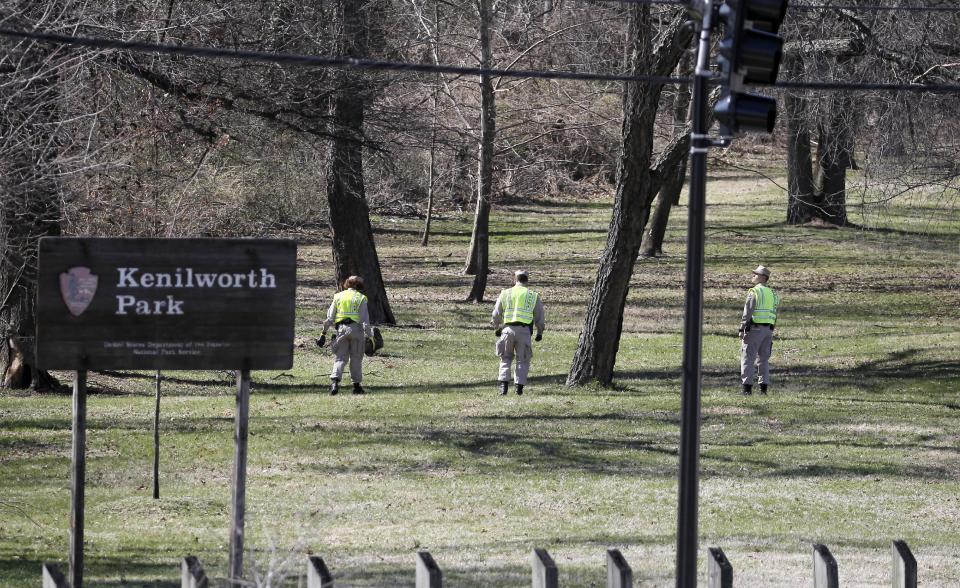 Washington Metro Police and cadets search in Kenilworth Park in Washington, Monday, March 31, 2014. Police have been searching the park in northeast Washington since last week for clues in the case of eight-year-old Relisha Rudd, last seen in the company of Kahlil Tatum, a janitor at the homeless shelter where she lived with her mother and brothers.(AP Photo/Alex Brandon)