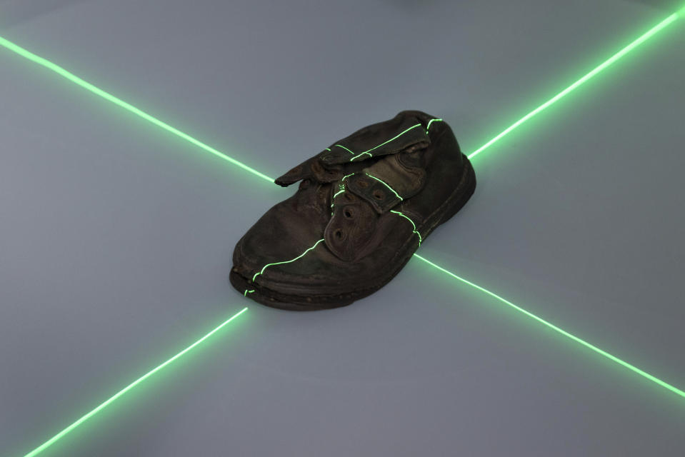 A shoe that belonged to a child victim of the former Nazi German death camp Auschwitz-Birkenau is scanned at the conservation laboratory on the grounds of the camp in Oswiecim, Poland, Wednesday, May 10, 2023. Most of the victims were Jews killed in dictator Adolf Hitler's attempt to exterminate the Jews of Europe. (AP Photo/Michal Dyjuk)