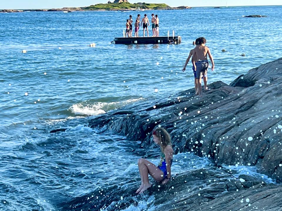 people swimming in the water on the coast of newport rhode island