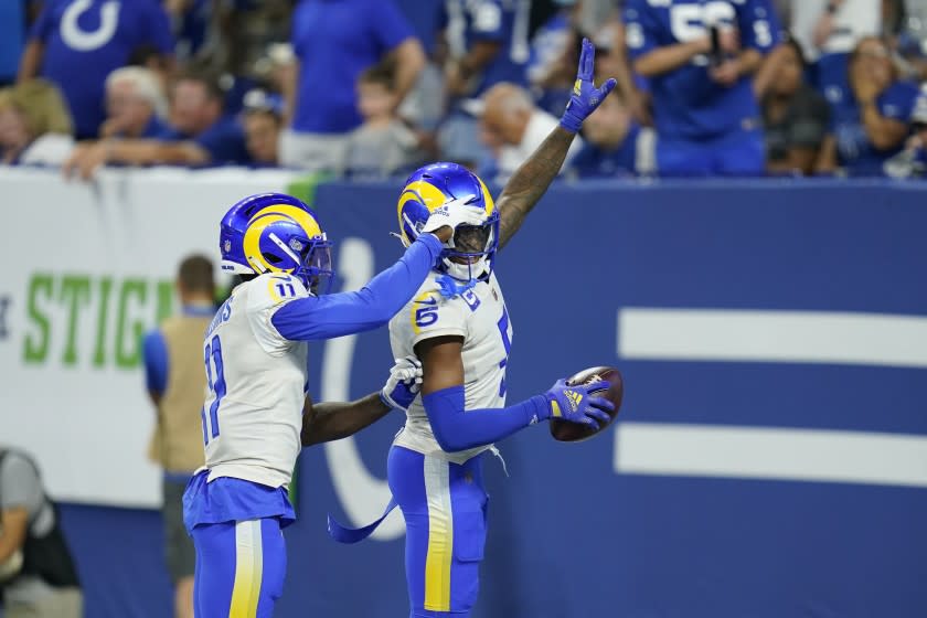 Los Angeles Rams' Jalen Ramsey (5) celebrates his interception with Darious Williams (11) during the second half of an NFL football game against the Indianapolis Colts, Sunday, Sept. 19, 2021, in Indianapolis. (AP Photo/Michael Conroy)