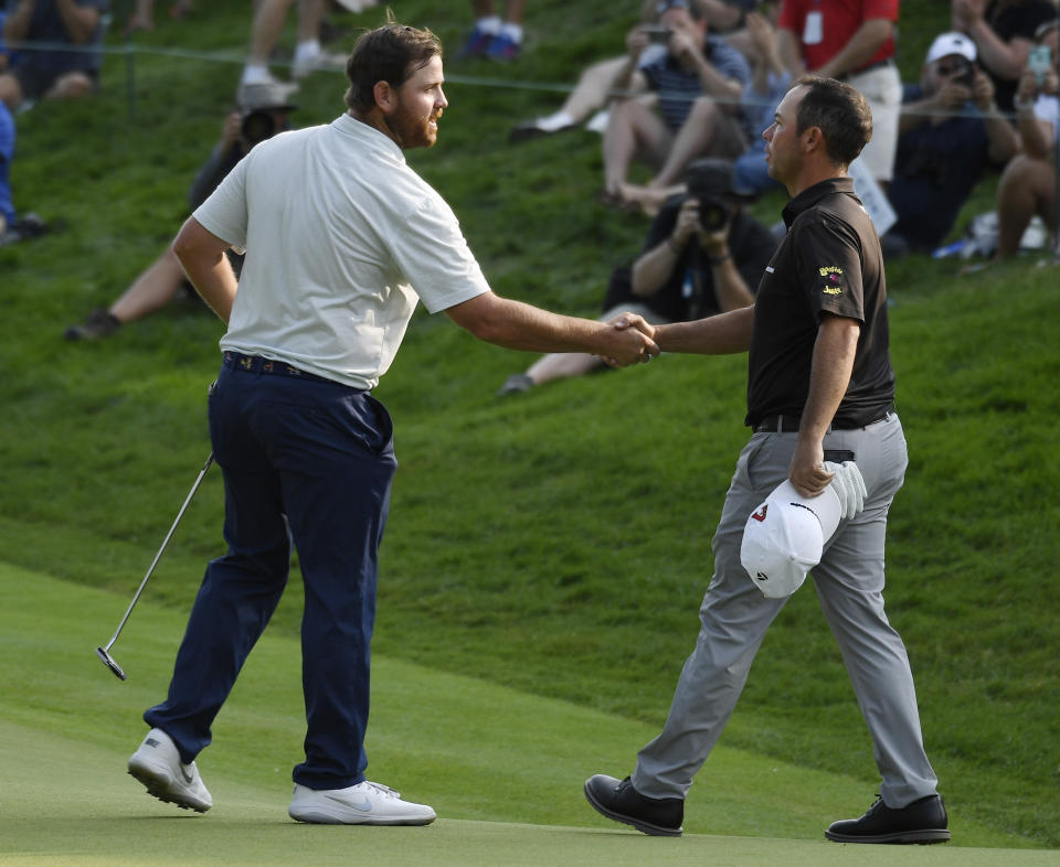 Zack Sucher, left, shakes hands with Chez Reavie as they finished the third round of the Travelers Championship golf tournament Saturday, June 22, 2019, in Cromwell, Conn. (AP Photo/Jessica Hill)