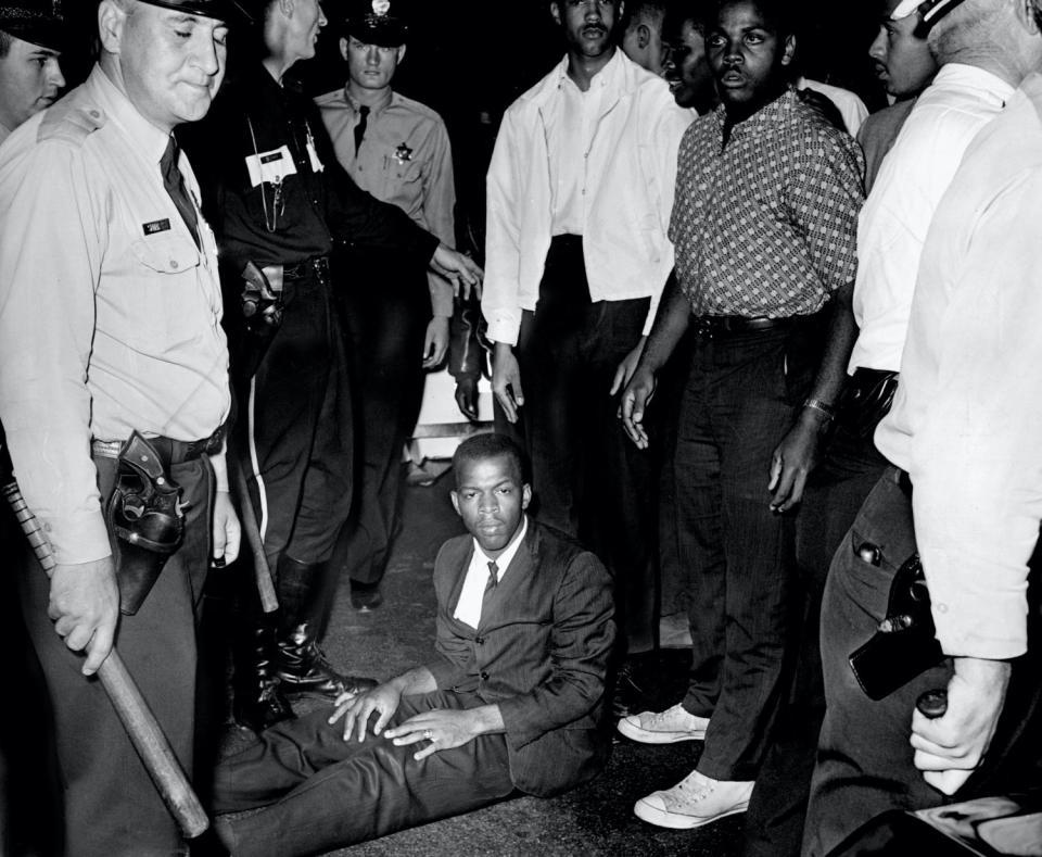 John Lewis sits in the street in the aftermath of a sit-in demonstration in front of the B & W Cafeteria in Nashville.