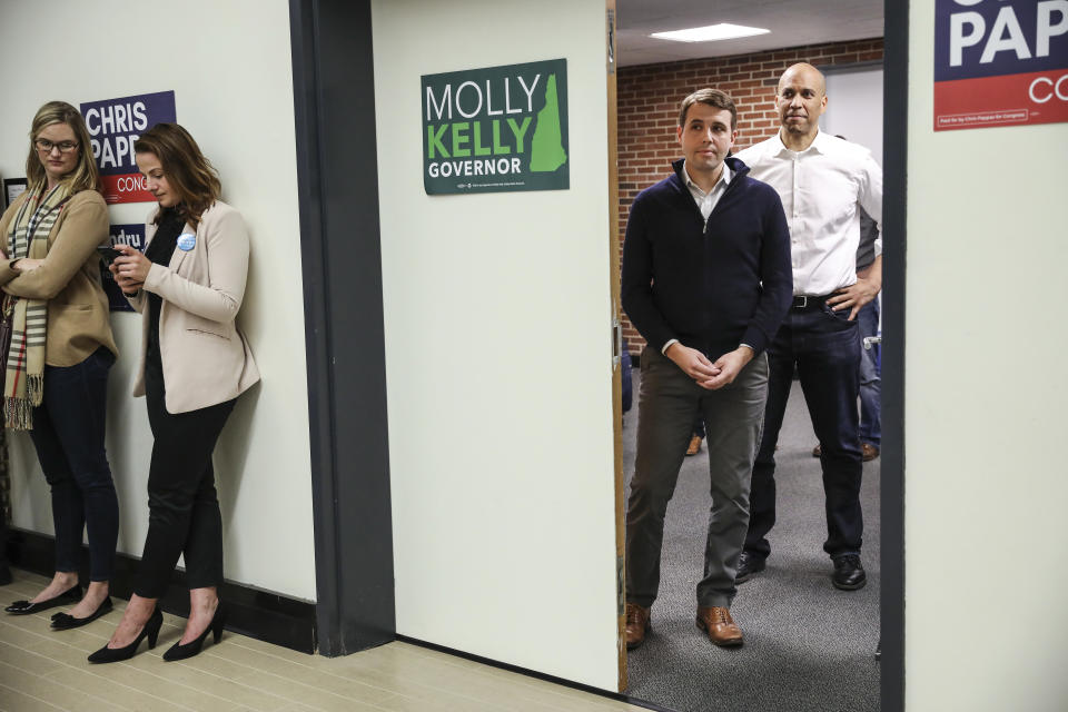 Democrats Chris Pappas, left, New Jersey Sen. Cory Booker wait in the wings to be introduced at a get out the vote event hosted by the New Hampshire Young Democrats at University of New Hampshire in Durham, N.H. Sunday, Oct. 28, 2018. (AP Photo/Cheryl Senter)