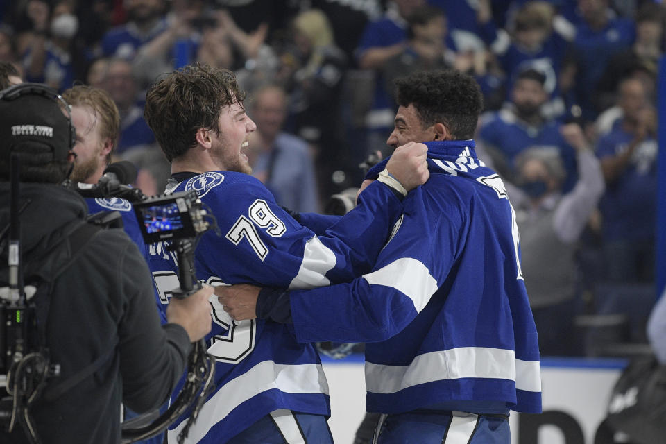 Tampa Bay Lightning left wing Ross Colton (79) celebrates with right wing Mathieu Joseph (7) after the Lighting defeated the Montreal Canadiens 1-0 in Game 5 of the NHL hockey Stanley Cup finals, Wednesday, July 7, 2021, in Tampa, Fla. (AP Photo/Phelan Ebenhack)