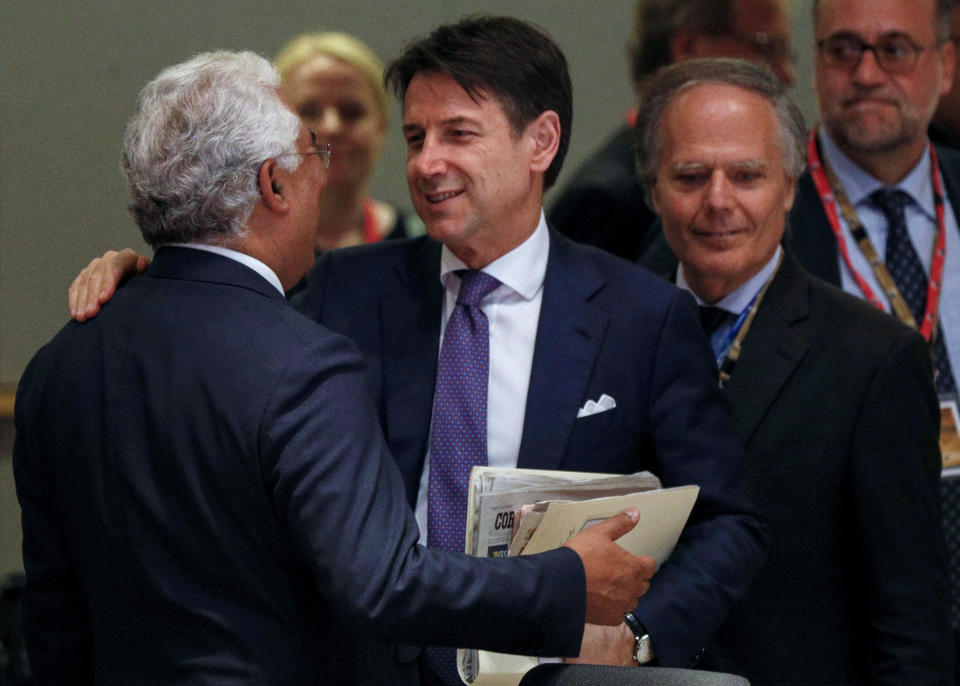 Italian Prime Minister Giuseppe Conte, center, speaks with Portuguese Prime Minister Antonio Costa, left, during a round table meeting at an EU summit in Brussels, Sunday, June 30, 2019. European Union leaders have started another marathon session of talks desperately seeking a breakthrough in a diplomatic fight over who should be picked for a half dozen of jobs at the top of EU institutions. (Geoffroy Van Der Hasselt, Pool Photo via AP)