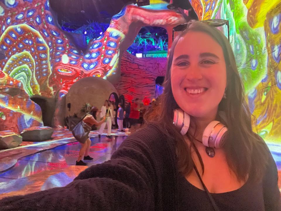 A selfie of the author is surrounded by colorful lights on the walls.