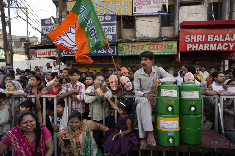 People wait at a crossroad to cheer Indian Prime Minister Narendra Modi during an election campaign of Bharatiya Janata Party (BJP) for the upcoming national elections in Ghaziabad, India, April 6, 2024. India is in election mode with colorful, and frenzied, campaign underway by various political parties to woo voters across the country. From April 19 to June 1, nearly 970 million Indians or over 10% of the global population are eligible to vote in India's general election. (AP Photo/ Manish Swarup)