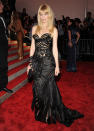 <p>Claudia Schiffer vamped things up in 2009, wearing a structured black and nude design by Versace.</p>